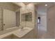 Bathroom showcasing a vanity, toilet, large mirror, and decorative wallpaper at 6330 99Th N Way # 14F, St Petersburg, FL 33708