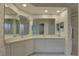 Bathroom featuring dual sinks, ample counter space, neutral wall paper, and walk-in shower at 6330 99Th N Way # 14F, St Petersburg, FL 33708