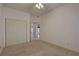 Bedroom with double door closet features a neutral color scheme and doorway to other rooms at 6330 99Th N Way # 14F, St Petersburg, FL 33708