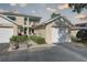 Two-story condo featuring a private balcony, vibrant green awnings, and a well-manicured, landscaped walkway at 6330 99Th N Way # 14F, St Petersburg, FL 33708