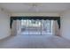 Expansive living room featuring glass doors to a covered deck area and wall-to-wall carpeting at 6330 99Th N Way # 14F, St Petersburg, FL 33708