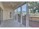 Enclosed patio offers an idyllic setting with tiled flooring, ceiling fan, and sliding glass doors leading to the outdoors at 6330 99Th N Way # 14F, St Petersburg, FL 33708