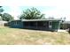 View of the back exterior, highlighting the covered patio and fenced yard for privacy and relaxation at 708 Pearl Cir, Brandon, FL 33510