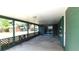 Spacious covered patio with green accents and sliding glass doors leading to the home's interior at 708 Pearl Cir, Brandon, FL 33510