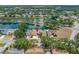 This property offers a stunning aerial perspective, highlighting its beautiful surroundings, including mature trees and lake views at 709 47Th E St, Bradenton, FL 34208