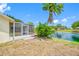 Backyard featuring a screened in porch and view of the lake at 709 47Th E St, Bradenton, FL 34208
