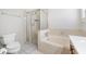 Bathroom featuring a soaking tub, separate shower, and neutral tile work at 709 47Th E St, Bradenton, FL 34208
