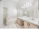 Bright bathroom with double sinks, soaking tub, and separate shower at 709 47Th E St, Bradenton, FL 34208