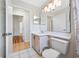 Clean bathroom featuring white tile, a vanity with ample counter space, and modern lighting at 709 47Th E St, Bradenton, FL 34208