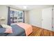 Bedroom features a large window with neighborhood views and wood floors at 709 47Th E St, Bradenton, FL 34208