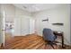 View of a bright bedroom with hardwood floors, closet, and a neutral wall color scheme at 709 47Th E St, Bradenton, FL 34208