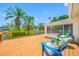 Backyard featuring a wooden deck with seating that overlooks a serene lake at 709 47Th E St, Bradenton, FL 34208