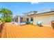 Large wooden deck with a view of the lake and access to a screened in porch at 709 47Th E St, Bradenton, FL 34208
