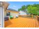 Backyard view featuring a large wooden deck with seating, solar panels, and a yard at 709 47Th E St, Bradenton, FL 34208