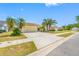 A charming single-story home featuring a spacious driveway and mature palm trees at 709 47Th E St, Bradenton, FL 34208
