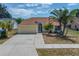 Inviting single-Gathering home with a two-car garage and lush tropical landscaping at 709 47Th E St, Bradenton, FL 34208