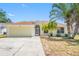 Charming single-story home with a well-maintained lawn, palm trees, and attached two car garage at 709 47Th E St, Bradenton, FL 34208