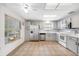 Well-lit kitchen featuring stainless steel appliances, light cabinets, and durable tiled flooring at 709 47Th E St, Bradenton, FL 34208