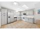 Bright kitchen with stainless steel appliances, ample white cabinets, and tile floors for easy maintenance at 709 47Th E St, Bradenton, FL 34208