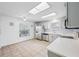 Spacious, well-lit kitchen with stainless steel appliances, white cabinetry, and tile flooring at 709 47Th E St, Bradenton, FL 34208