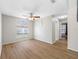 Bright living room featuring wood-look floors, a large window, and a ceiling fan at 709 47Th E St, Bradenton, FL 34208
