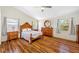Spacious main bedroom featuring hardwood floors and vaulted ceilings for a luxurious feel at 709 47Th E St, Bradenton, FL 34208