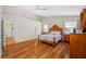 Spacious main bedroom featuring hardwood floors and vaulted ceilings leading to the ensuite bathroom at 709 47Th E St, Bradenton, FL 34208
