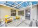 Enclosed patio overlooking a lake with inviting seating at 709 47Th E St, Bradenton, FL 34208