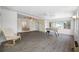 Bright sunroom with tile floors, comfortable chair, large windows, and a foosball table at 709 47Th E St, Bradenton, FL 34208
