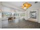 Bright sunroom with tile floors, large windows, and a foosball table for indoor fun at 709 47Th E St, Bradenton, FL 34208