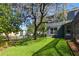 Large backyard featuring a luscious green lawn with plenty of space for outdoor activities at 7310 Brightwater Oaks Dr, Tampa, FL 33625