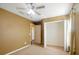 Bedroom features neutral carpet, a ceiling fan and a spacious walk-in closet for storage at 7310 Brightwater Oaks Dr, Tampa, FL 33625