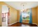 Dining room with hardwood floors, chandelier, and view to the backyard at 7310 Brightwater Oaks Dr, Tampa, FL 33625