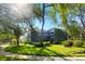 Green two-story home with well-maintained lawn, mature landscaping and a charming curb appeal at 7310 Brightwater Oaks Dr, Tampa, FL 33625