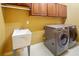 Laundry room features washer, dryer, and utility sink at 7310 Brightwater Oaks Dr, Tampa, FL 33625