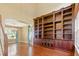 Elegant living room featuring hardwood floors, tall bookcase, and natural light at 7310 Brightwater Oaks Dr, Tampa, FL 33625