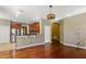 Bright living area featuring wood floors, natural light, and easy kitchen access at 7310 Brightwater Oaks Dr, Tampa, FL 33625