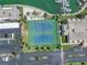Aerial shot featuring tennis courts and a marina, complete with lush tropical landscaping at 7625 Sun Island S Dr # 106, South Pasadena, FL 33707