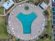 The aerial view shows a uniquely shaped pool, ample deck space, and lush tropical landscaping at 7625 Sun Island S Dr # 106, South Pasadena, FL 33707