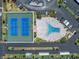 Aerial view displays well-maintained tennis courts and a uniquely shaped pool within the community at 7625 Sun Island S Dr # 106, South Pasadena, FL 33707