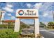 Bay Island community signage is beautifully designed with mature shrubbery and lush landscaping at 7625 Sun Island S Dr # 106, South Pasadena, FL 33707