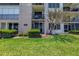Condo building exterior with grass and tree at 7625 Sun Island S Dr # 106, South Pasadena, FL 33707