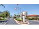 Welcoming entrance to Bay Island with lush landscaping, flags, and clear signage for a beautiful first impression at 7625 Sun Island S Dr # 106, South Pasadena, FL 33707