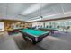 Game room featuring multiple billiard tables, bar seating, and stylish lighting at 7625 Sun Island S Dr # 106, South Pasadena, FL 33707