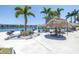 Community grilling area with multiple grills, tiki umbrellas, picnic tables, and waterfront views for outdoor gatherings at 7625 Sun Island S Dr # 106, South Pasadena, FL 33707