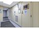 Hallway with elevator access, utility box, and visible safety signs for resident convenience and security at 7625 Sun Island S Dr # 106, South Pasadena, FL 33707