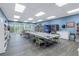 Well-lit meeting room with a large table, vending machine, and bookshelves for community gatherings at 7625 Sun Island S Dr # 106, South Pasadena, FL 33707