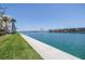 Serene water view showcasing the building's waterfront location, beautiful landscaping, and the tranquil canal at 7625 Sun Island S Dr # 106, South Pasadena, FL 33707