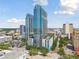 Beautiful aerial view of the modern high-rise building, surrounded by urban greenery and blue skies with puffy clouds at 777 N Ashley Dr # 2603, Tampa, FL 33602