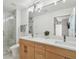 Bright bathroom with double sink vanity, contemporary lighting, and glass-enclosed shower at 777 N Ashley Dr # 2603, Tampa, FL 33602